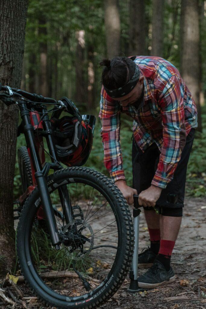 Biker Checking Tire Air Pressure